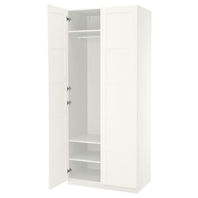 White PAX wardrobe, minimalist design, three compartments, hanging rail, two shelves, soft-close doors.