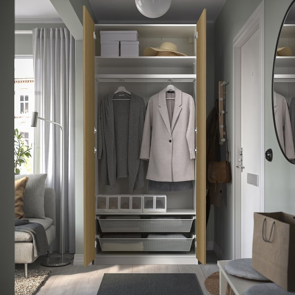 Closed wardrobe displaying clothes, hats, and storage boxes.