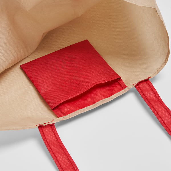 Foldable beige bag with red accents; durable, eco-friendly design.