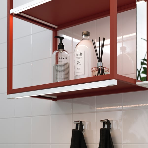 Red shelf with led light, soap, lotion, diffuser