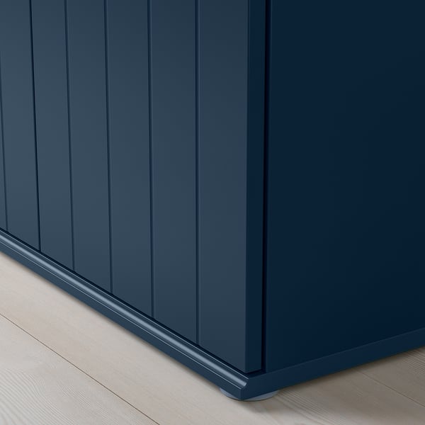 Dark wooden cabinet with vertical grooves, sleek handles, and sturdy base, exuding quality craftsmanship.