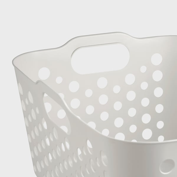 White perforated plastic laundry basket with rounded handles, sturdy and ventilated.