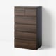 Brown wooden 6-drawer STORKLINTA chest, modern, against white wall.