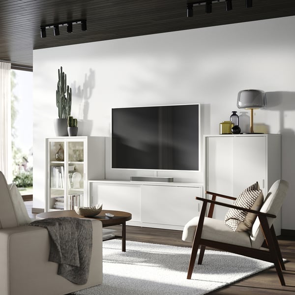 Modern living room with off-white TONSTAD tv unit, sliding doors, soft lighting, wooden accents, and cosy seating.