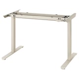 A beige TRAVSPORT adjustable height desk frame, made from steel and plastic components, designed for ergonomic use.