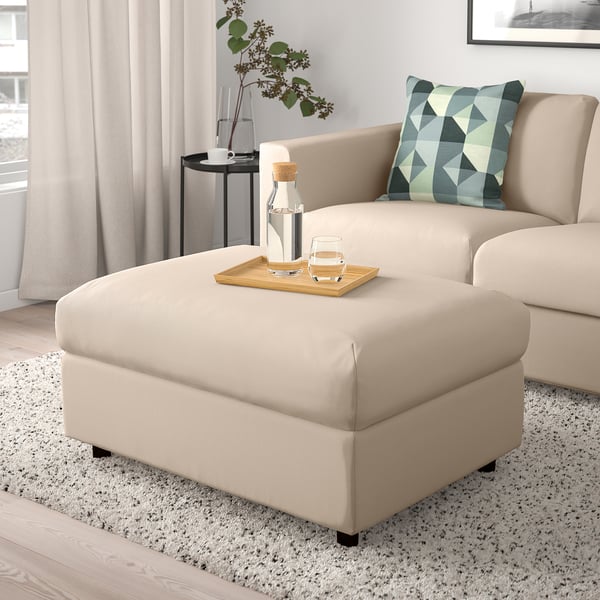 Beige VIMLE footstool with storage, matching sofa, tray with drinks, plant.
