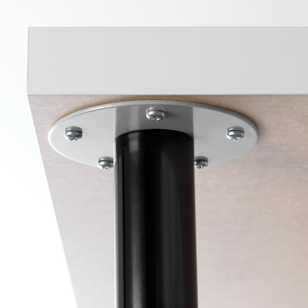 Close-up of table leg attachment: sturdy metal base securely fastened with screws.