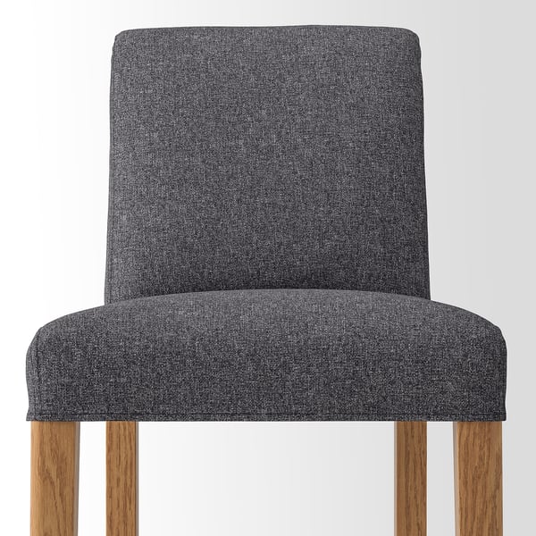Grey upholstered bar stool with wooden legs. Comfortable, cushioned seat and backrest.