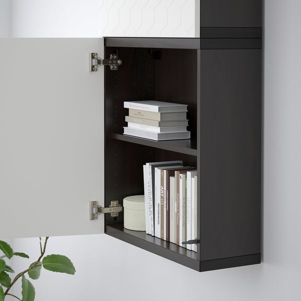 Black wall-mounted bookshelf with two shelves holding books.