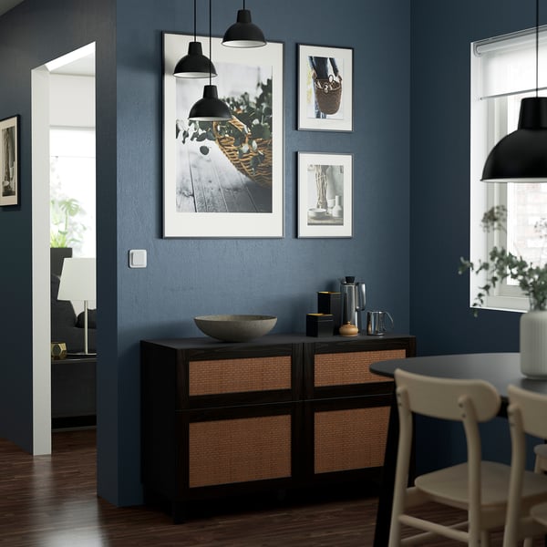 Modern living room with dark blue walls, BESTÅ sideboard, art, decor, plant, doorway.