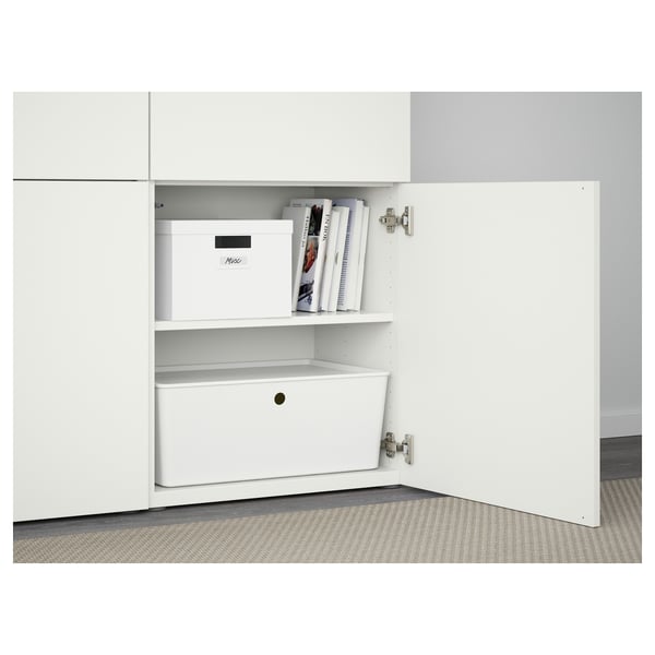 White BESTÅ cabinet with shelves and storage box. Soft-close hinges visible, one shelf adjustable.