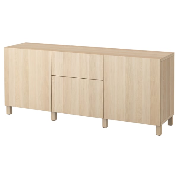 Depicts a light-colored wood sideboard with integrated drawers and cabinets. It a sleek, minimalist design with tapered legs.