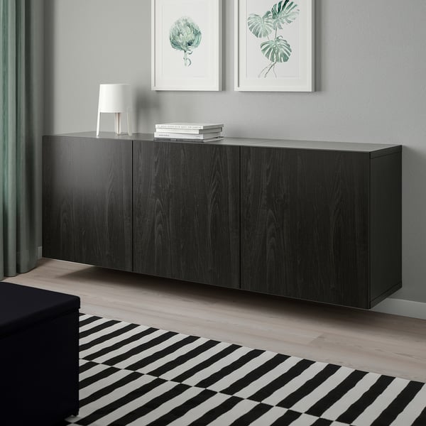 Dark wooden cabinet with three sections, larger size than surrounding items.