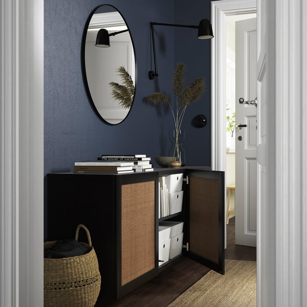 Modern entryway with open storage cabinet, mirror, and wall sconces.