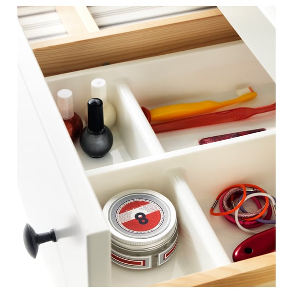 Organised bathroom drawer with multiple compartments holding items like nail polish, toothbrush, and hair ties.