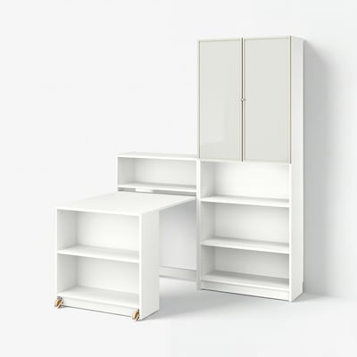 Displays a white BILLY bookcase set with both open and closed storage, featuring a foldable table on casters for flexibility and functionality.