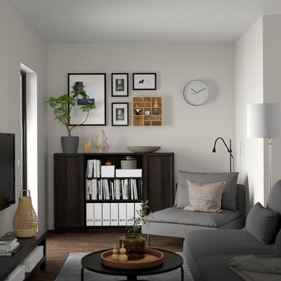 Modern living room with grey BILLY bookcase, sofa, clock, and decor.