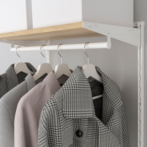 A modern closet with white hanging rods and wooden shelves holding jackets and other clothes.