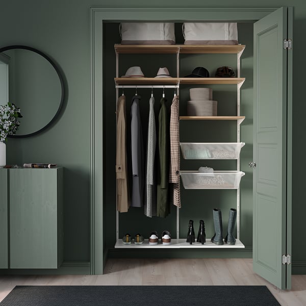 Green BOAXEL wall storage: shelves, hooks, baskets for outdoor clothing.