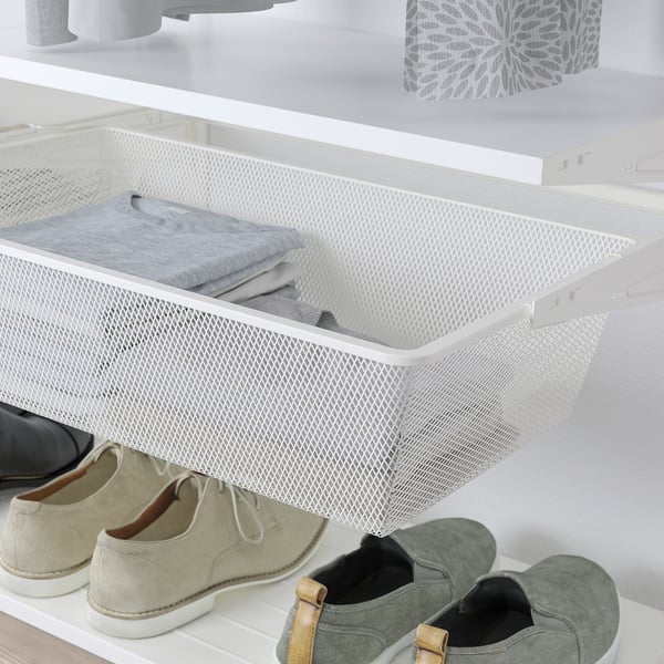 White mesh storage drawer holds folded clothes, mounted inside closet, keeps small items organised.