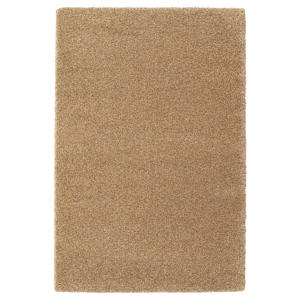 A rectangular brebärare rug in beige, featuring a soft texture and round, short pile made from polypropylene.
