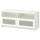 A white BRIMNES tv stand with four compartments, two glass doors, and two open shelves for storage and cable management.