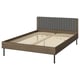 BRUKSVARA bed: brown wood finish frame, grey padded headboard, metal legs, minimalist design.
