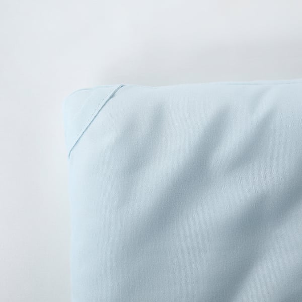 A corner of a soft, light blue duvet. When described, it highlights the fluffy texture, clean lines, and quality construction.