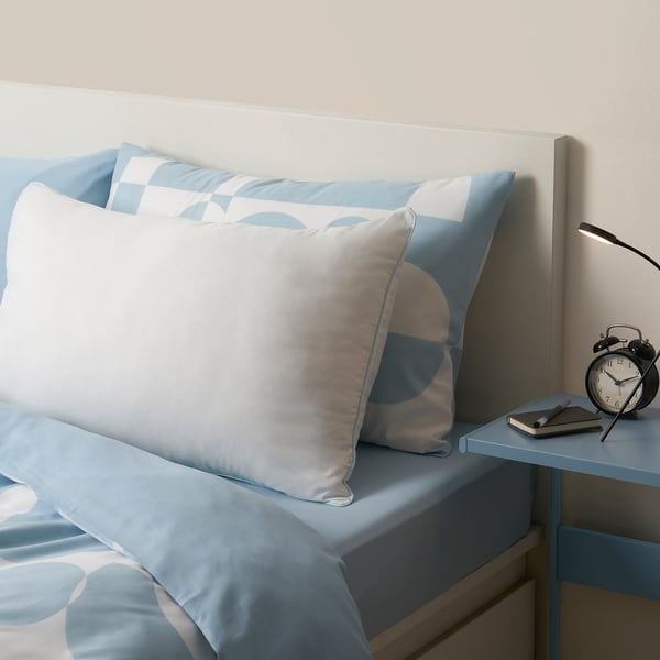 BRUKSVARA light blue dust miteallergenic pillow on bed, soft microfiber, rectangular.