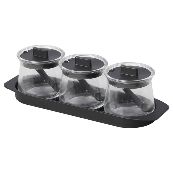 Three glass containers with black lids and spoons in a black tray. Its the CELEBRERA product, transparent and easy to clean.