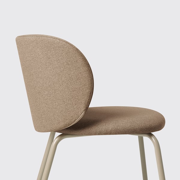 Modern chair with curved back and seat, upholstered in beige fabric, supported by metal legs.