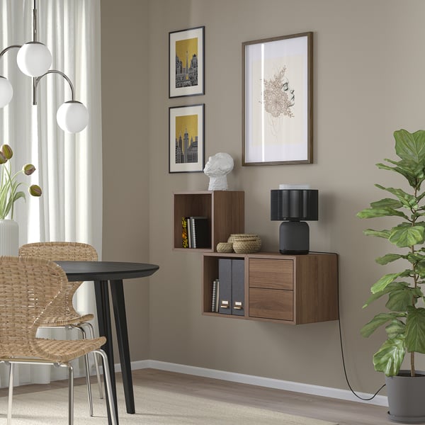 Modern living room with EKET shelves, art, and round table with globe light.