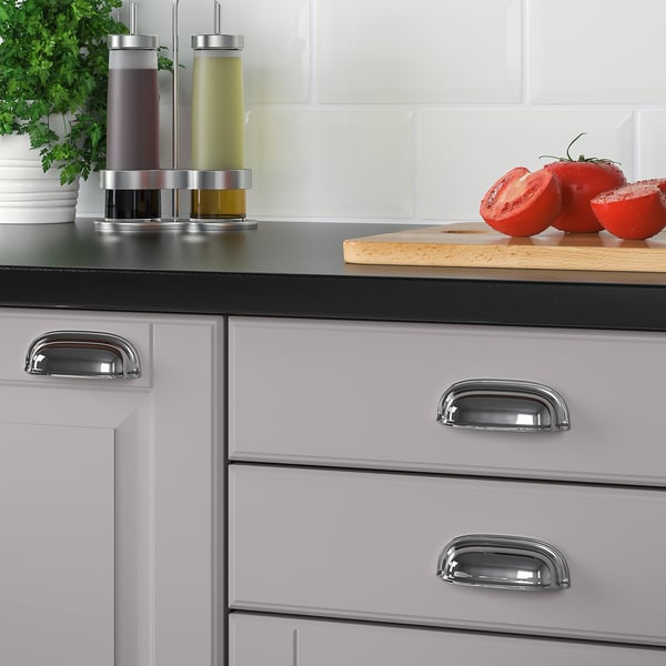 Modern kitchen cabinets with chrome handles and knobs showcasing a sleek, traditional design.