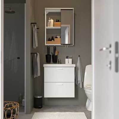 Modern bathroom with ENHET vanity, mirror cabinet, sink, towels, toilet, and shower.