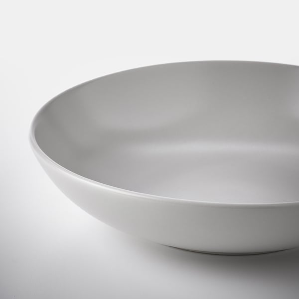 Smooth, matte white bowl with rounded edges on a white surface.