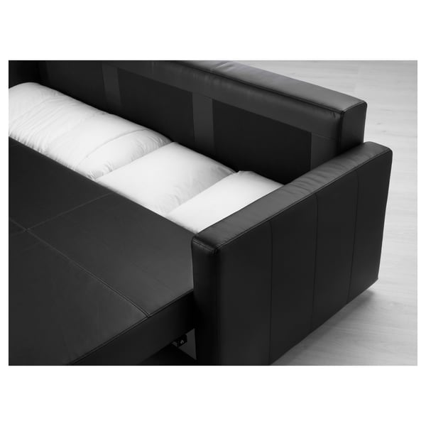 Black sofa illustrating its storage functionality with cushions partially pulled out.