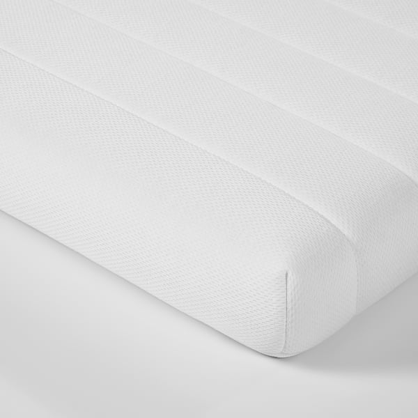Close-up of a smooth, white, high-quality mattress with textured fabric, folded neatly.