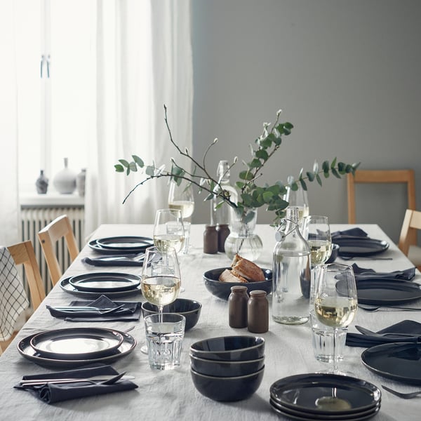 Dark grey GLADELIG tableware with greenery.