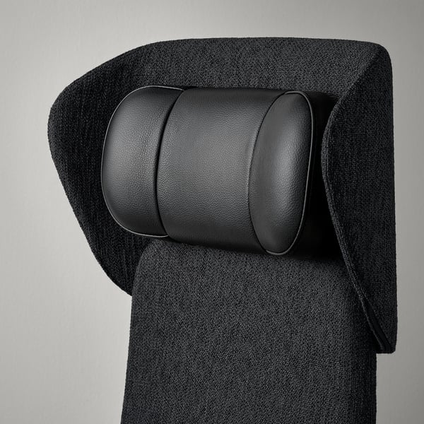 Black leather headrest on a grey fabric chair, showcasing high-quality materials and design.