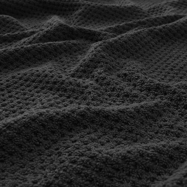 Soft, thick, black towel with textured weave, showcasing high quality and absorbency.