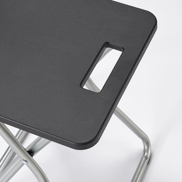 Modern lightweight black stool with metal legs, foldable for easy storage.