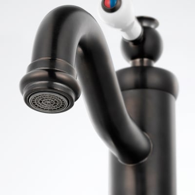 Black tap with sleek curve, small aerator tip, and metallic shine, mounted on a white background.