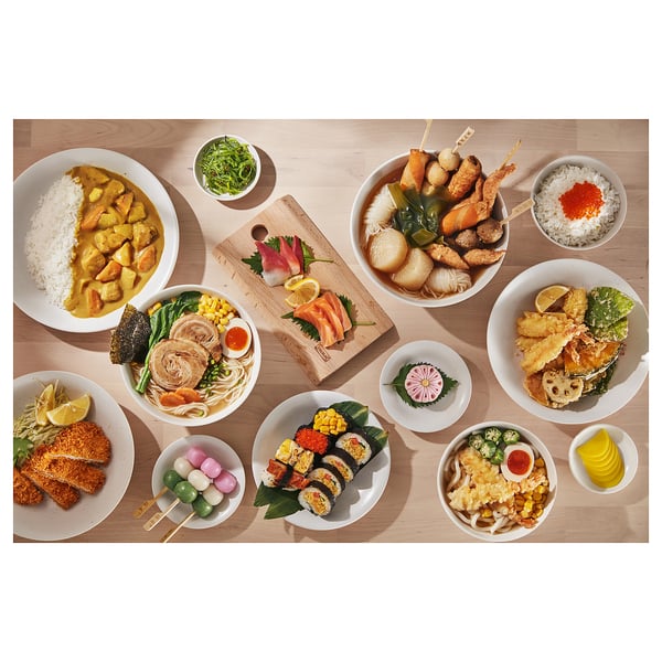 Japanese meal: sushi, tempura, rice, curry, radish, lemon, pickles, salmon.