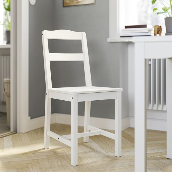 White wooden HAUGA chair, simple design, fits under table.