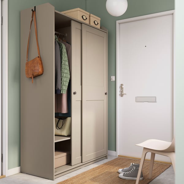 Modern beige HAUGA wardrobe with open door, inside storage & shelves, wall-mounted.