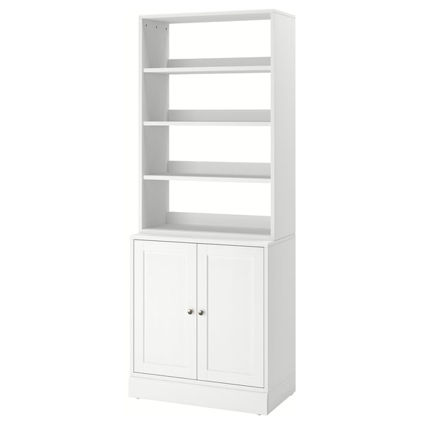 A white HAVSTA shelf unit made from solid pine, featuring open and closed storage spaces with a rustic design.