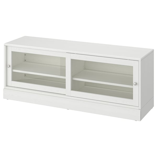 A white HAVSTA tv bench with glass doors, displaying a rustic pine wood design. It a rectangular shape with sliding doors for cable management.