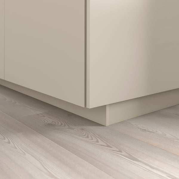 Beige HAVSTORP kitchen plinth covers floor gap, part of metod series.