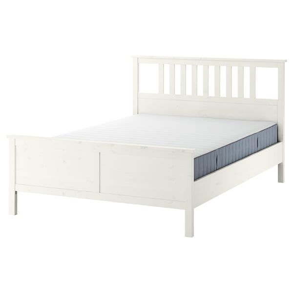 A white HEMNES wooden bed with adjustable sides, featuring a high headboard and footboard, and a slatted bed base.