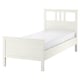 White HEMNES solid wood bed with adjustable sides and memory foam mattress.